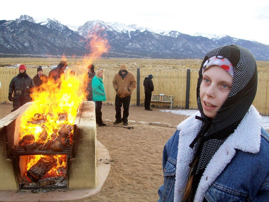 Brandi Ellis, 18, talks to a reporter during the outdoor cremation of her mother, Belinda Ellis, 48, in Crestone, Colo., on Jan. 12. The funeral industry says Crestone is the only place in the U.S. where anyone, regardless of religion, can have a funeral pyre. (Associated Press)