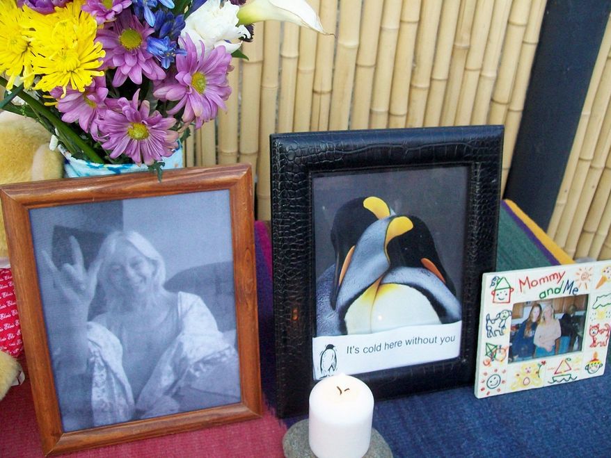 Photographs, flowers and other tributes arranged by Mrs. Ellis' family are set out at the site of her outdoor cremation. (Associated Press)