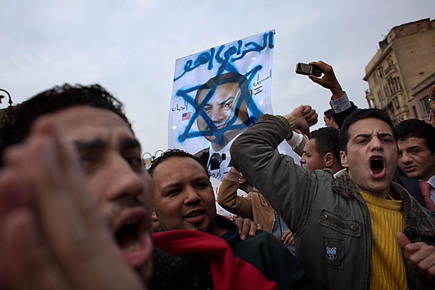 Anti-government protesters shout slogans as they march toward Tahrir, or Liberation, Square in downtown Cairo on Tuesday, Feb. 1, 2011. More than a quarter-million people flooded into the heart of Cairo, filling the city's main square in by far the largest demonstration in a week of unceasing demands for President Hosni Mubarak to leave after nearly 30 years in power. (AP Photo/Emilio Morenatti)