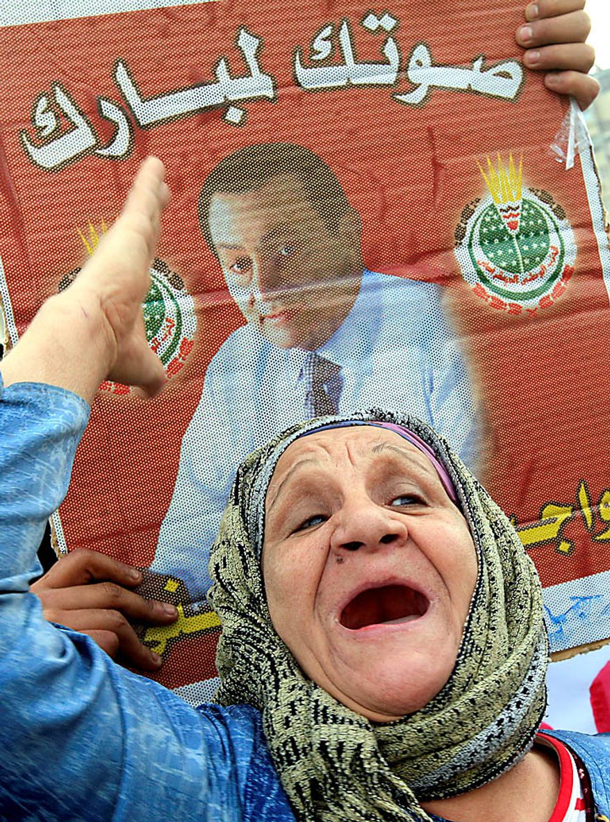 An elderly Egyptian pro-Mubarak supporter shouts slogans during a demonstration in Cairo on Tuesday, Feb. 1, 2011. Egyptian authorities battled to save President Hosni Mubarak's regime with a series of concessions and promises to protesters, but realities on the streets of Cairo may be outrunning his capacity for change. The Arabic poster, dating from the 2005 presidential elections, reads, "Your vote to Mubarak." (AP Photo/Amr Nabil)