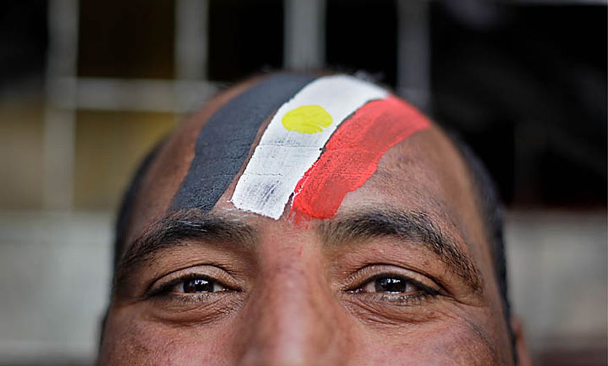 An anti-government protester wears face paint in the colors of the Egyptian flag during the continuing demonstrations in Tahrir Square in downtown Cairo on Tuesday, Feb. 1, 2011. More than a quarter-million people flooded into the heart of Cairo, filling the city's main square in by far the largest demonstration in a week of unceasing demands for President Hosni Mubarak to leave after nearly 30 years in power. (AP Photo/Ben Curtis)