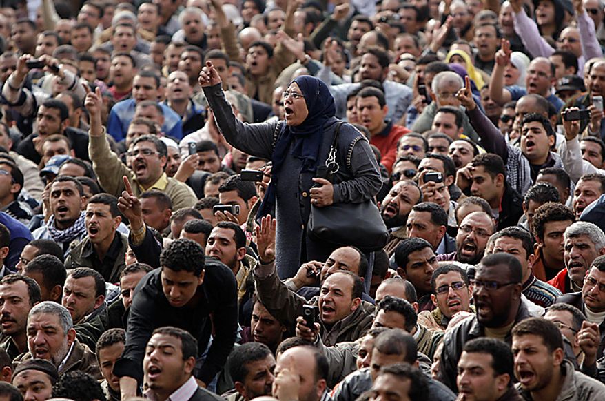 A demonstrator reacts in Tahrir, or Liberation, Square in Cairo on Tuesday, Feb. 1, 2011. More than a quarter-million people flooded into the heart of Cairo, filling the city's main square in by far the largest demonstration in a week of unceasing demands for President Hosni Mubarak to leave after nearly 30 years in power. (AP Photo/Ben Curtis)