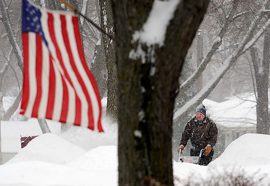Arnie Kooistra clears his driveway of snow on Monday, Jan. 31, 2011, in Sioux Falls, S.D. (AP Photo/Argus Leader, Jay Pickthorn)