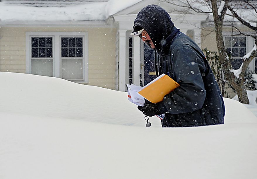 Mail carrier Don Jacques makes his rounds during a winter storm in Hartford, Conn., on Tuesday, Feb. 1, 2011. (AP Photo/Jessica Hill)