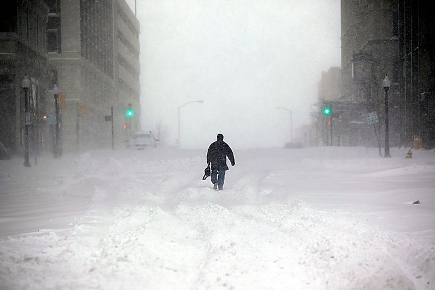 Tim Houchin walks to work in the snow in downtown Tulsa, Okla., on Tuesday, Feb. 1, 2011. Blizzard conditions struck the Tulsa area, stranding motorists and shutting down much of the city. (AP Photo/Tulsa World, Christopher Smith)