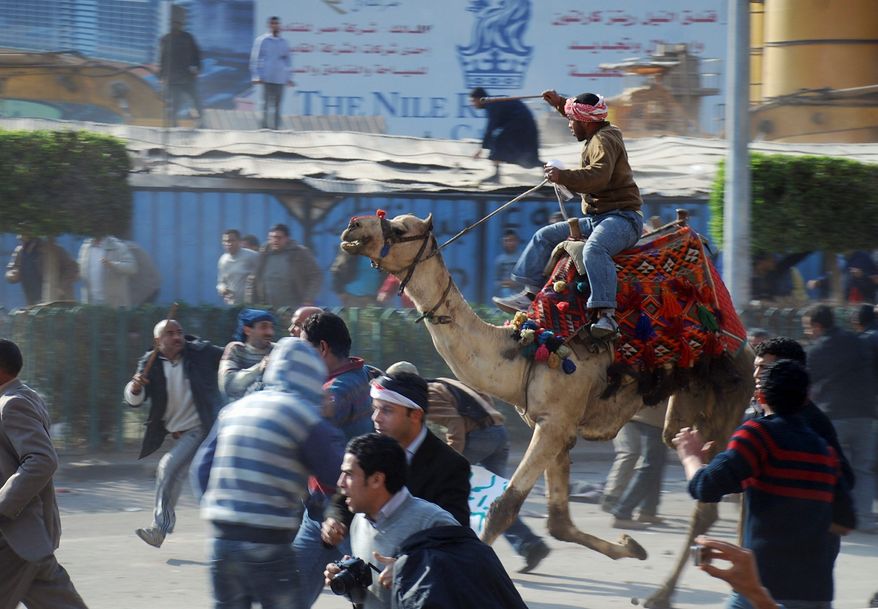 Riding a camel, a supporter of Egyptian President Hosni Mubarak fights with anti-Mubarak protesters in the streets of Cairo on Wednesday, Feb. 2, 2011, as Egypt's upheaval took a violent turn in its ninth day. (Associated Press)