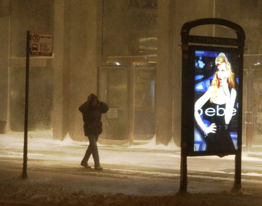 A man braces himself during a blizzard Tuesday, Feb. 1, 2011 in Chicago. The city received 17 inches of snow overnight, and more snow was forecast for Wednesday. (AP Photo/Charles Rex Arbogast)