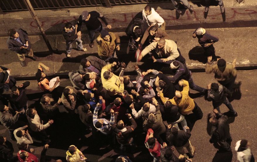 Supporters of Egyptian President Hosni Mubarak scuffle with anti-government protesters near Tahrir, or Liberation, Square in central Cairo on Wednesday, Feb. 2, 2011. (AP Photo/Lefteris Pitarakis)
