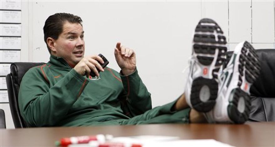 Miami head coach Al Golden gestures as he talks to coaches in the meeting room during signing day in Coral Gables, Fla., Wednesday, Feb. 2, 2011. (AP Photo/Alan Diaz)