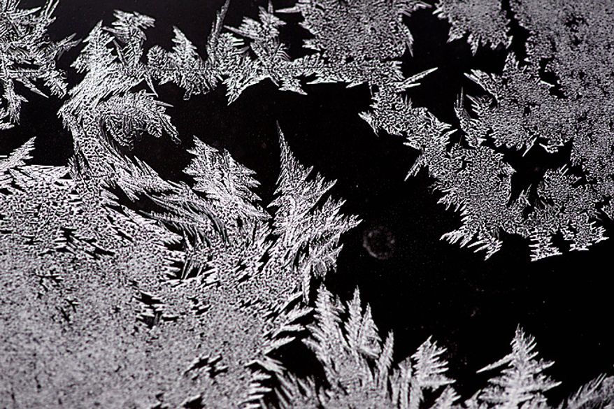 Frost forms on a window during the winter weather in Buffalo, N.Y., Wednesday, Feb. 2, 2011. (AP Photo/David Duprey)