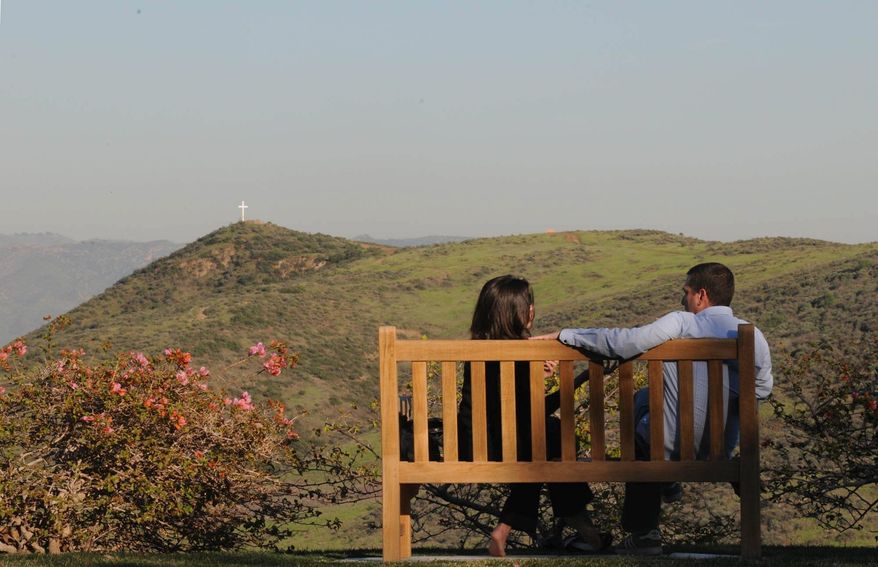 Rachel Duffy of Wisconsin and Matt Kunitz of Los Angeles relax on a park bench overlooking the Santa Susana Mountains at the Ronald Reagan Library and Museum in Simi Valley, Calif. (Garrett Cheen/Special to The Washington Times)