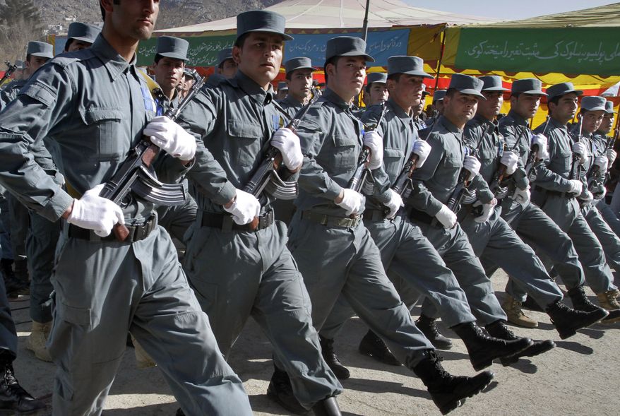 ** FILE ** Afghan policemen march during their graduation ceremony in Kabul, Afghanistan, on Saturday, Jan. 22, 2011. U.S. and NATO troops are trying to speed up the training of Afghan policemen and soldiers so they can take the lead in providing security. (AP Photo/Musadeq Sadeq)