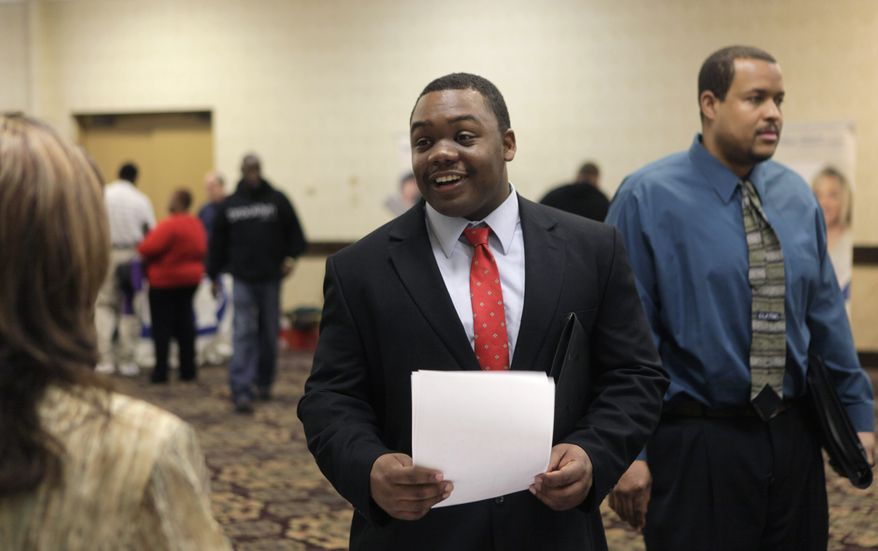 Lee Owens (center) looks to hand out his resume during a job fair at a hotel in Dallas on Wednesday, Jan. 26, 2011. (AP Photo/L.M. Otero)