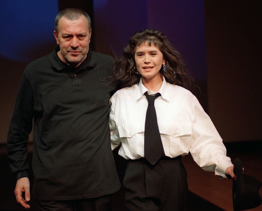** FILE ** In this Jan. 14, 1997, file photo, French actress Maria Schneider, who became famous with Bernardo Bertolucci in his 1972 scandal-movie "Ultimo Tango a Parigi" (Last Tango in Paris), walks the catwalk with Italian stylist Luciano Soprani after the unveiling of his men's collection for the Fall-Winter in Milan. A representative of the Act 1 agency said Schneider died in Paris on Thursday, Feb. 3, 2011, following a long illness. She was 58. (AP Photo/Antonio Calanni, file)