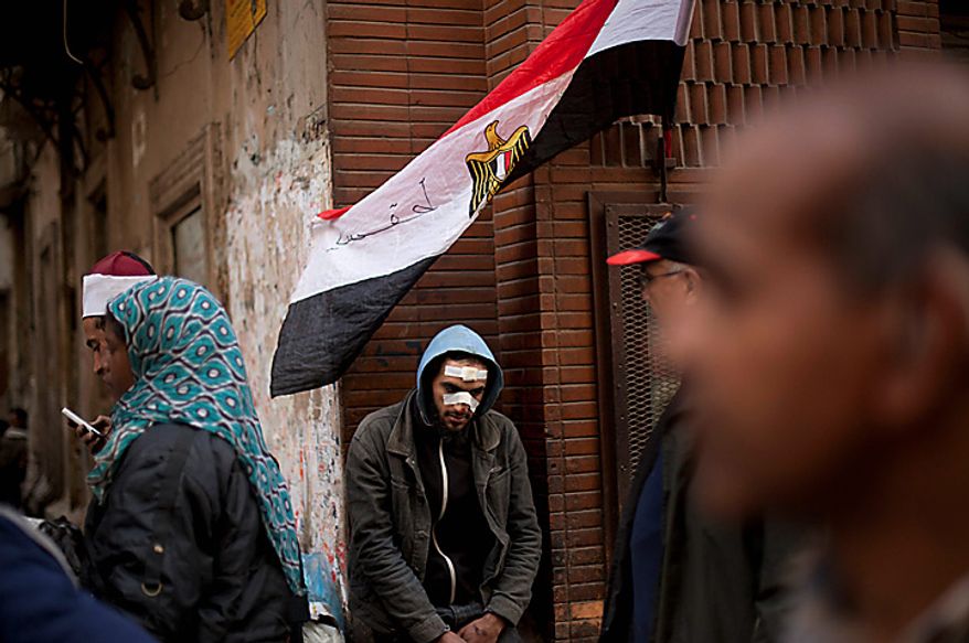 A wounded Egyptian anti-government protester rests during clashes in Cairo's main square Thursday, Feb. 3, 2011. Another bout of heavy gunfire and clashes erupted Thursday around dusk in the Cairo square at the center of Egypt's anti-government chaos, while new looting and arson spread around the capital. (AP Photo/Emilio Morenatti)