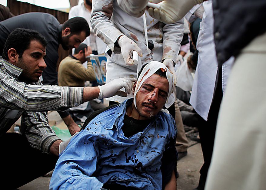 Egyptian doctors and medics treat an injured protester near Tahrir, or Liberation, Square in Cairo Thursday, Feb. 3, 2011. (AP Photo/Tara Todras-Whitehill)