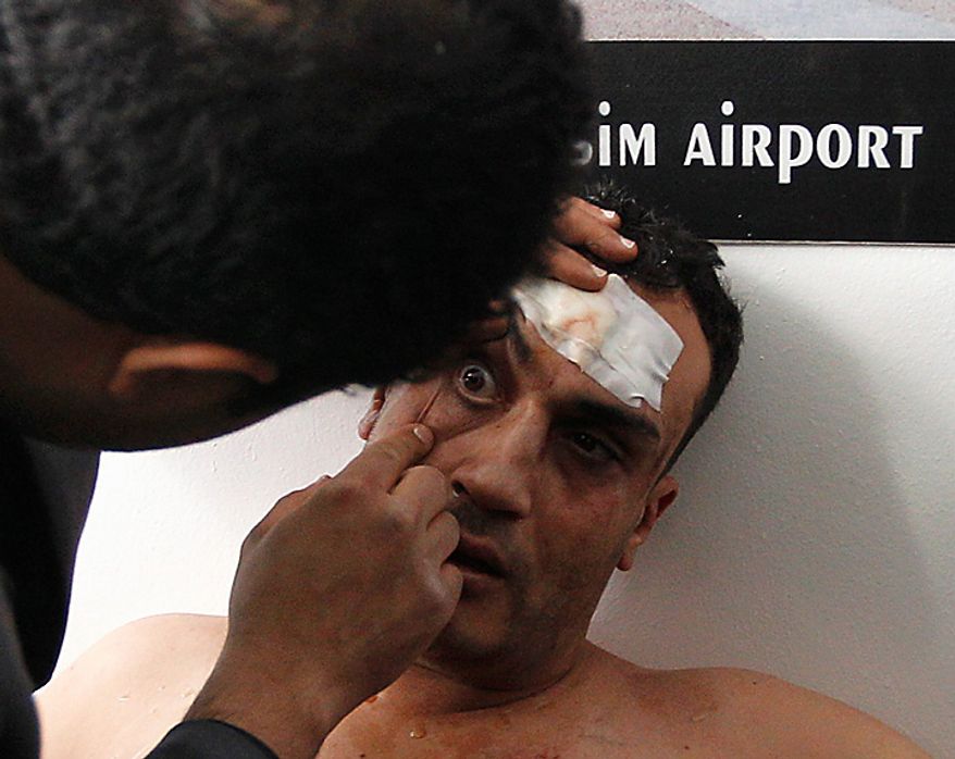 A wounded pro-government supporter is being treated after being captured by anti-government protesters in Cairo's main square Thursday, Feb. 3, 2011. (AP Photo/Tara Todras-Whitehill)
