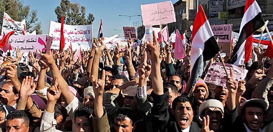 Yemeni demonstrators raise their hands during a demonstration against the government, in Sanaa, Yemen, Thursday, Feb. 3, 2011. Thousands of opponents of Yemen's government and its supporters demonstrated in the capital and other cities a day after the president pledged not to seek another term in office. (AP Photo/Hani Mohammed)