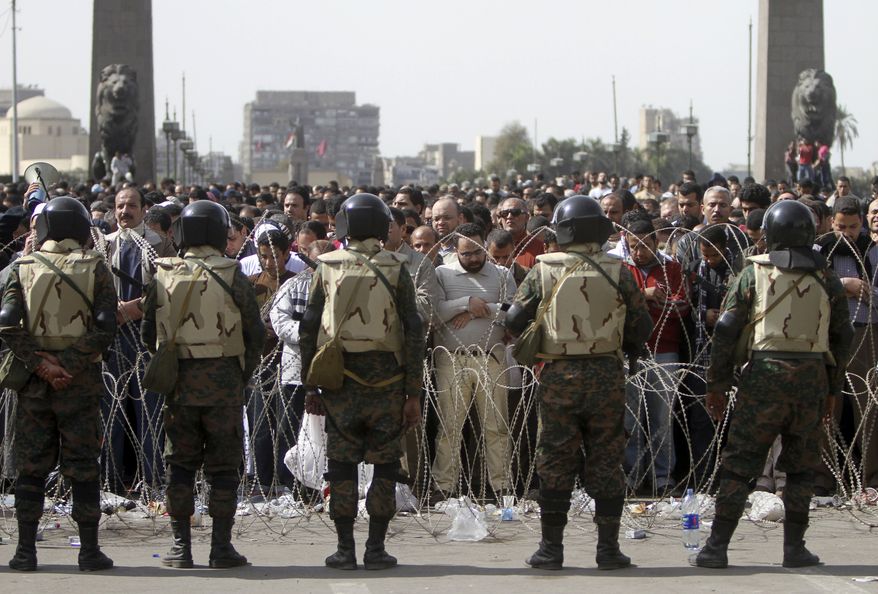 Egyptian protesters perform Friday prayers during a protest in Tahrir or Liberation Square in Cairo, Egypt Friday, Feb. 4, 2011. Protesters demanding President Hosni Mubarak's ouster packed Cairo's central square by the tens of thousands Friday, waving Egyptian flags, singing the national anthem and cheering, appearing undaunted and determined after their camp withstood two days of street battles with regime supporters trying to dislodge them. (AP Photo/Ahmed Ali)