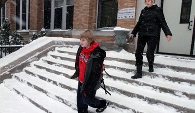 ASSOCIATED PRESS PHOTOGRAPHS
Erik Yehl, 11, leaves school with his mother, Kirsten. Like King George VI, whose battle to overcome stuttering is depicted in &quot;The King&#x27;s Speech,&quot; Erik struggles with the speech impediment. The movie&#x27;s powerful message for him is, &quot;I&#x27;m not stupid.&quot; 