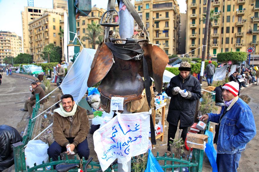 ASSOCIATED PRESS PHOTOGRAPHS
Egyptian protesters display a saddle as a trophy they seized in violence last week when pro-government combatants, some on horseback, attacked demonstrators in Cairo's Tahrir Square.