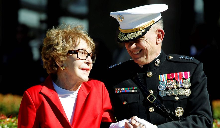 Former first lady Nancy Reagan is assisted by Marine Lt. Gen. George J. Flynn at a wreath-laying ceremony for former President Ronald Reagan during his centennial birthday celebration in Simi Valley, Calif., in 2011. (Associated Press) ** FILE **