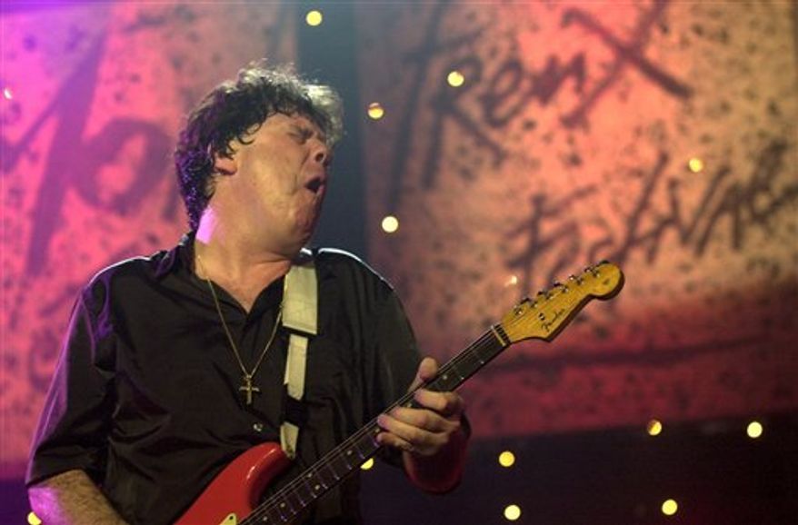 FILE - In this Friday, July 6, 2001 file photo, Irish musician Gary Moore performs on the Stravinski hall stage during the " Rock'n Blues" at the opening night of the 35th Montreux Jazz Festival in Montreux, Switzerland. Bandmates say rock guitarist Gary Moore, a former member of influential Irish band Thin Lizzy, has died. He was 58. Manager Adam Parsons told the BBC that Moore was found dead Sunday at a hotel on Spain's Costa del Sol, where he was on holiday. The cause of death was not immediately known. (AP Photo/Keystone/Martial Trezzini, File)