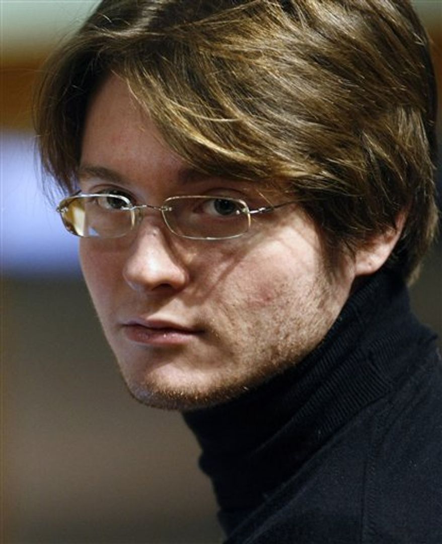 FILE - This is a Thursday, Dec. 3, 2009 file photo of convicted murderer Amanda Knox from the US as she is escorted by penitentiary police officers during a break in the trial at the court in Perugia, central Italy, The father of slain British student Meredith Kercher is criticizing a U.S. television re-enactment for depicting alleged scenes of his daughter's murder in the Italian city of Perugia. The Lifetime movie is based on the trial that followed Meredith Kercher's stabbing death on Nov. 1, 2007 a killing for which Kercher's roommate, University of Washington student Amanda Knox, was found guilty, along with two men. They have all proclaimed their innocence. (AP Photo/Pier Paolo Cito, File)