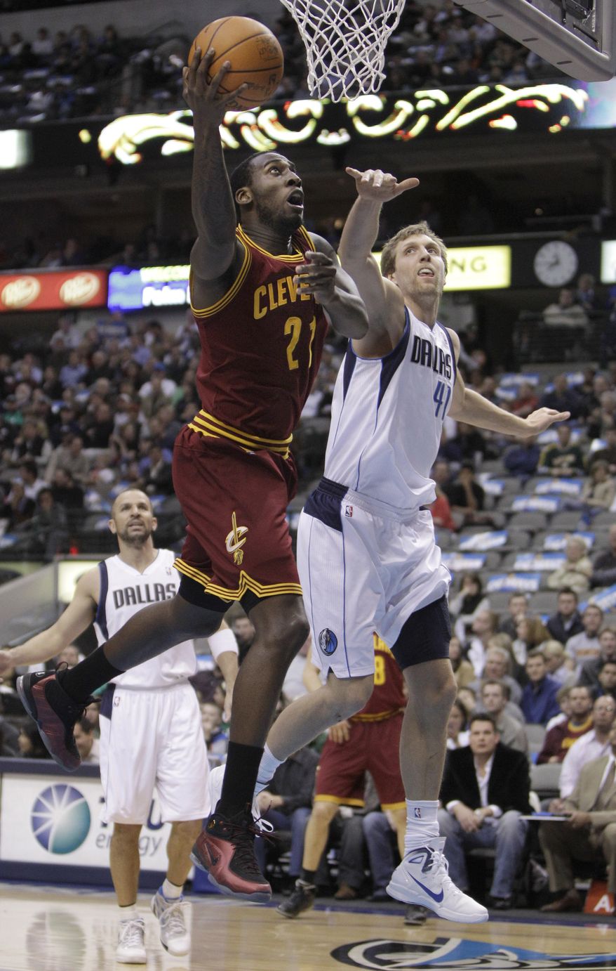 Cleveland Cavaliers power forward J.J. Hickson (21) shoots against Dallas Mavericks power forward Dirk Nowitzki (41) during the first half of a NBA basketball game in Dallas on Monday, Feb. 7, 2011. (AP Photo/LM Otero)