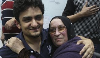 Egyptian Wael Ghonim, a Google Inc. marketing manager who became a hero of the demonstrators since he went missing on Jan. 27, hugs the mother of Khaled Said, a 28-year-old businessman who died in June 2010 at the hands of undercover police, on Tuesday at Tahrir Square in Cairo. (Associated Press)