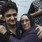 Egyptian Wael Ghonim, a Google Inc. marketing manager who became a hero of the demonstrators since he went missing on Jan. 27, hugs the mother of Khaled Said, a 28-year-old businessman who died in June 2010 at the hands of undercover police, on Tuesday at Tahrir Square in Cairo. (Associated Press)