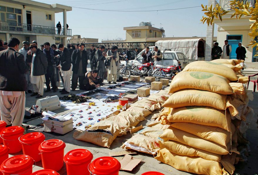 Opium sacks, motor bikes and explosives confiscated by Afghan security forces in Kandahar are shown; allied forces are trying to make it harder for the Taliban to launch a spring offensive. (Associated Press)