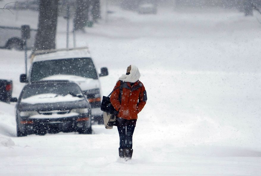 Allie Blair walks through the snow in Tulsa, Okla., on Wednesday, Feb. 9, 2011. The second winter storm to hit the state in just more than a week has dropped up to 16 inches of snow on parts of northeastern Oklahoma. (AP Photo/Tulsa World, Mike Simons)