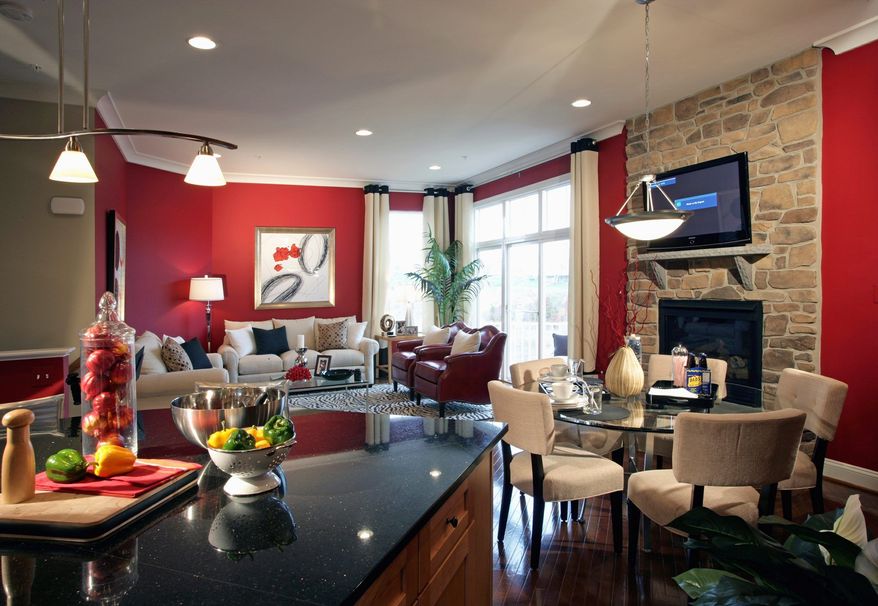 The great room in the Merlin model at Autumn Walk at Emerson has a wall of windows and an optional fireplace. It is priced from $389,990.