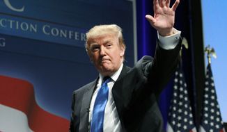 Donald Trump waves after addressing the Conservative Political Action Conference in Washington in February 2011. (AP Photo)