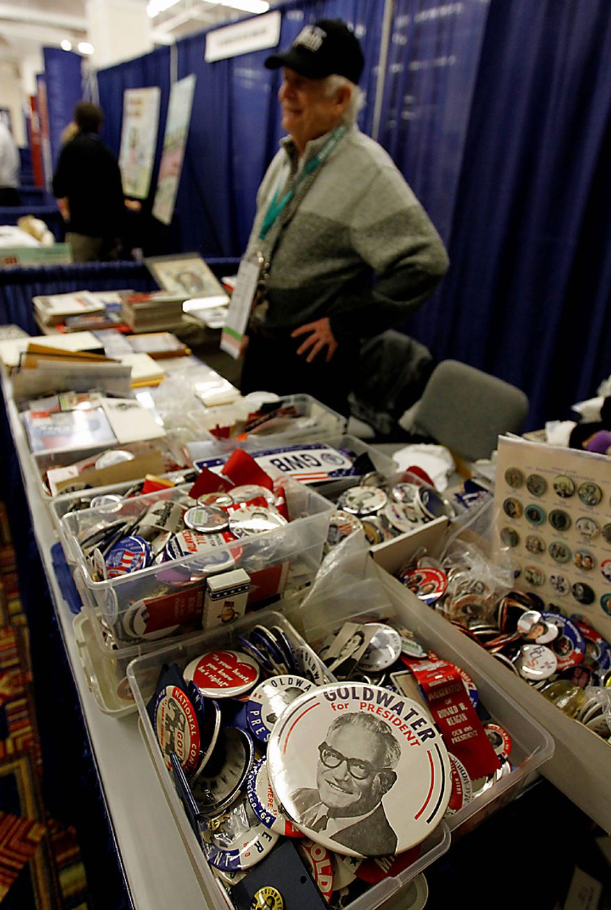 Frank Enten of Bethesda, Md., sells political memorabilia, including a "Goldwater for President" button (foreground), at the Conservative Political Action Conference (CPAC) in Washington on Thursday, Feb. 10, 2011. (AP Photo/Alex Brandon)