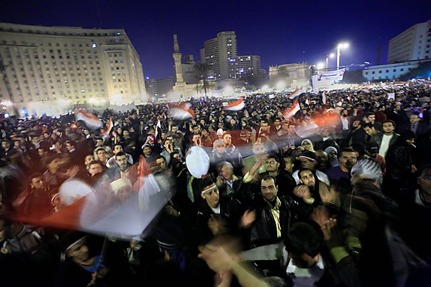 Anti-government protesters celebrate in Tahrir Square in downtown Cairo, Egypt, Thursday, Feb. 10, 2011. Egypt's military announced on national television it had stepped in to secure the country and promised protesters calling for President Hosni Mubarak's ouster that all their demands would soon be met. Tens of thousands of protesters packed in central Tahrir broke into chants of 'We're almost there, we're almost there' and waved V-for-victory signs as thousands more flowed in to join them well after nightfall. (AP Photo/Amr Nabil)