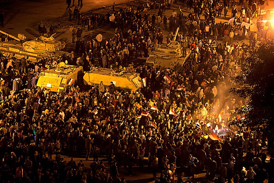Anti-government protesters celebrate in Tahrir Square in downtown Cairo, Egypt, Thursday, Feb. 10, 2011. Egypt's military announced on national television it had stepped in to secure the country and promised protesters calling for President Hosni Mubarak's ouster that all their demands would soon be met. Tens of thousands of protesters packed in central Tahrir broke into chants of "We're almost there, we're almost there" and waved V-for-victory signs as thousands more flowed in to join them well after nightfall. (AP Photo/Emilio Morenatti)