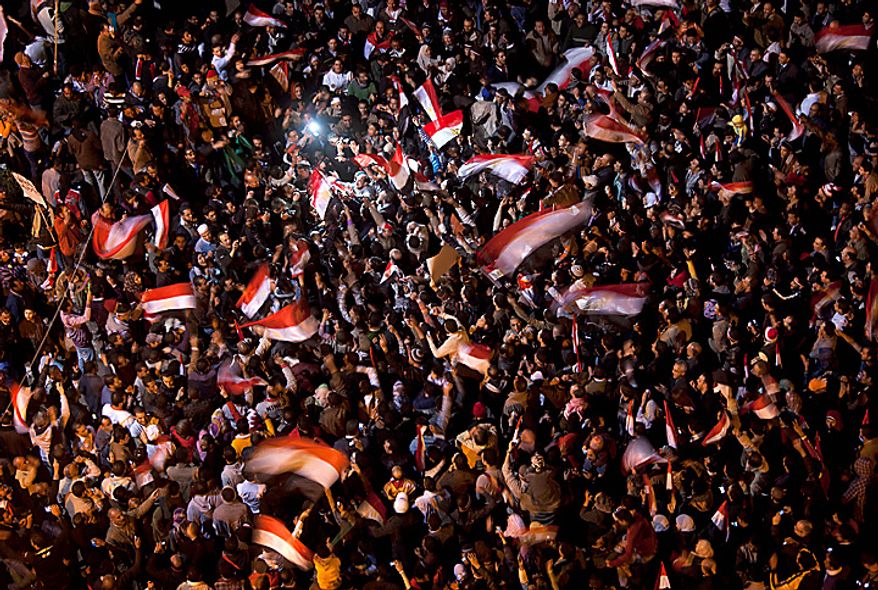Anti-government protesters celebrate in Tahrir Square in downtown Cairo, Egypt, Thursday, Feb. 10, 2011. Egypt's military announced on national television it had stepped in to secure the country and promised protesters calling for President Hosni Mubarak's ouster that all their demands would soon be met. Tens of thousands of protesters packed in central Tahrir broke into chants of "We're almost there, we're almost there" and waved V-for-victory signs as thousands more flowed in to join them well after nightfall. (AP Photo/Emilio Morenatti)