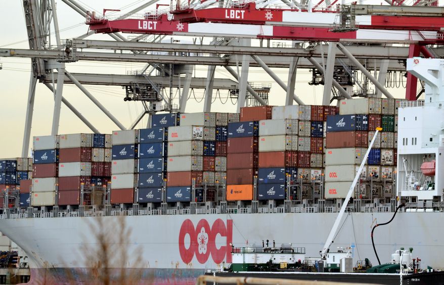 Shipping containers are loaded on a ship for export at the Port of Long Beach in Long Beach, Calif, on Jan. 10, 2011. The U.S. trade deficit widened in December, closing out a year in which America's trade gap ballooned by the largest amount in a decade.(AP Photo/Noaki Schwartz)