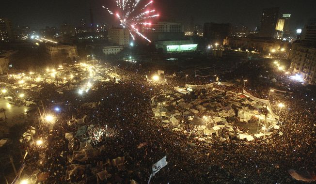Fireworks are seen over Tahrir Square as Egyptians celebrate after President Hosni Mubarak resigned and handed power to the military in Cairo, Egypt, Friday, Feb. 11, 2011. (AP Photo/Ahmed Ali)