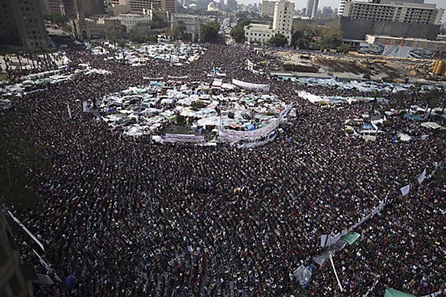 Anti-government protesters join in traditional Muslim Friday prayers in Tahrir Square in downtown Cairo, Egypt, Friday, Feb. 11, 2011. Hours later, the government announced that President Hosni Mubarak has stepped down. (AP Photo/Tara Todras-Whitehill)