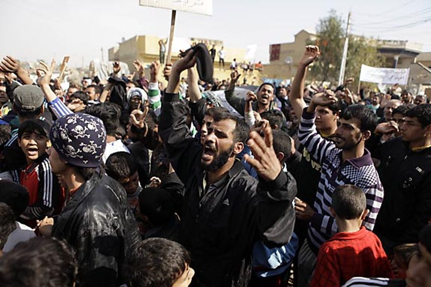 Protesters chant anti-government slogans during a demonstration in Baghdad, Iraq, Friday, Feb. 11, 2011. In at least four morning demonstrations across Baghdad, protesters painted a picture of their homeland that they said has fewer services and more corruption than in Egypt. (AP Photo/Karim Kadim)