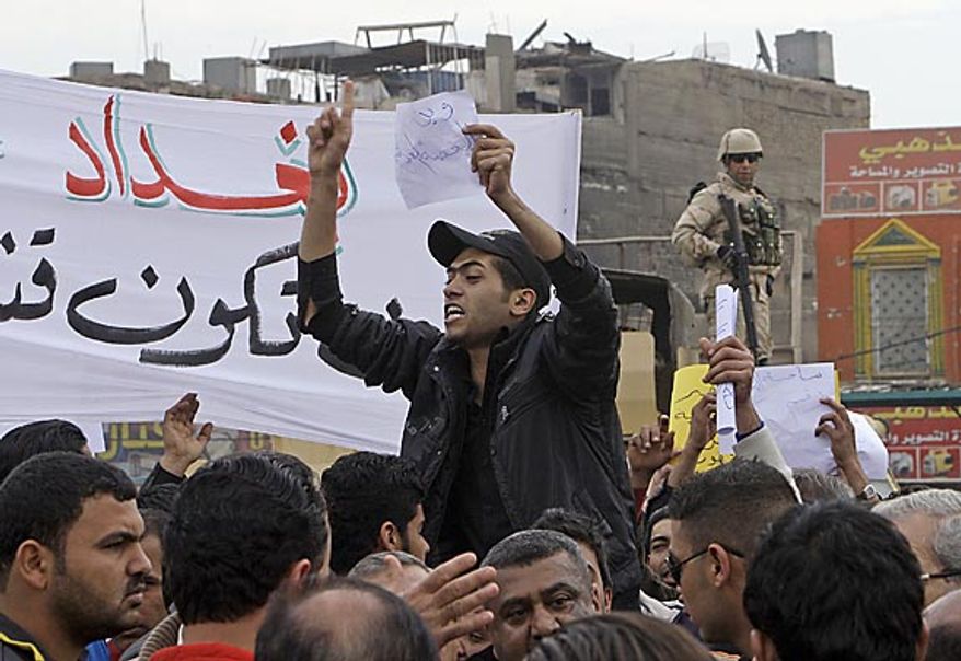 Protesters chant anti-government slogans during a demonstration in Baghdad, Iraq, Friday, Feb. 11, 2011. In at least four morning demonstrations across Baghdad, protesters painted a picture of their homeland that they said has fewer services and more corruption than in Egypt. The banners in Arabic read, "From Cairo to Baghdad, no for corruption" and "Maliki, like Saddam he do not care about orphans." (AP Photo/Khalid Mohammed)