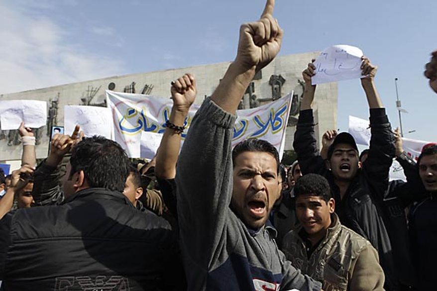 Protesters chant anti-government slogans during a demonstration in Baghdad, Iraq, Friday, Feb. 11, 2011. In at least four morning demonstrations across Baghdad, protesters painted a picture of their homeland that they said has fewer services and more corruption than in Egypt. The banners in Arabic read, "From Cairo to Baghdad, no for corruption" and "Maliki, like Saddam he do not care about orphans." (AP Photo/Khalid Mohammed)