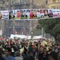 Egyptians pass under a banner honoring people who were killed during the Jan. 25 protests, at Tahrir Square, Egypt, on Saturday, Feb. 12, 2011. The Arabic sign reads &quot;who is responsible for their blood.&quot; (AP Photo/Amr Nabil)