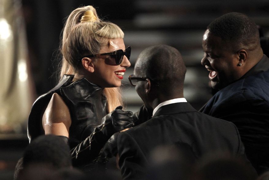 Lady Gaga is congratulated as she wins the award for best pop vocal album at the 53rd annual Grammy Awards on Sunday, Feb. 13, 2011, in Los Angeles. (AP Photo/Matt Sayles)