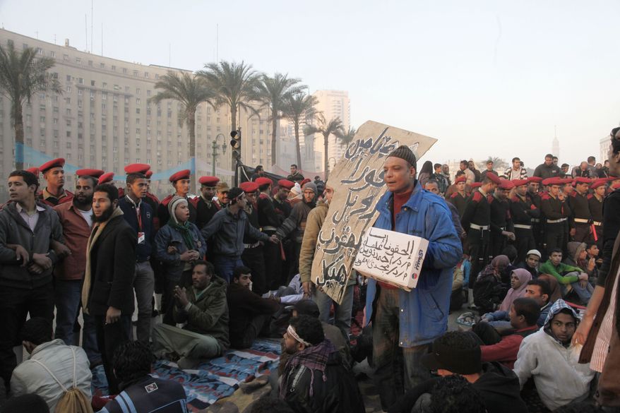 Egyptian soldiers surround the remaining protesters on Tahrir Square in Cairo on Sunday, Feb. 13, 2011, as the military tries to help people return to normal life. Protesters were debating whether to close down their 24-hour-a-day demonstration camp in their square. (AP Photo/Manoocher Deghati)