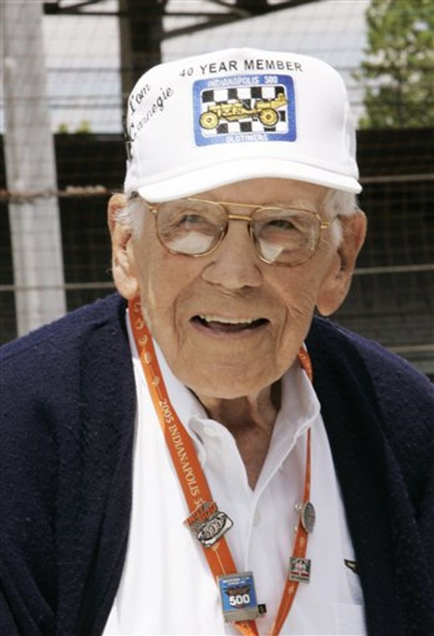 FILE - In this May 28, 2005 file photo, Tom Carnegie, track announcer at the Indianapolis Motor Speedway until 2006, is recognized during the annual Indy 500 drivers' meeting at the track. The longtime voice of the track died Friday, Feb. 11, 2011 at his home in Indianapolis. He was 91. (AP Photo/Al Behrman, File)