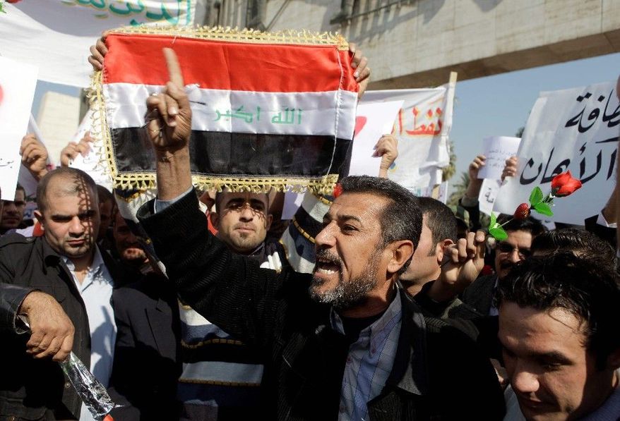 Protesters chant anti-government slogans during a demonstration in Baghdad on Monday. Hundreds of Iraqis rallied in central Baghdad against corruption and the lack of government services. (Associated Press)